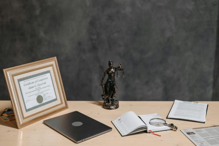 Diploma Figurine and Documents on a Desk